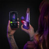 Person using a smartphone to adjust settings on the Peak Pro 3DXL Plasma