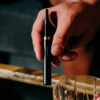 Person holding a black Vessel Core vape pen highlighting its compact and portable size. EU
