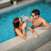 Dr. Dabber Ghost 2 concentrate vaporizer pictured with two people beside a pool