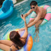 Person holding the compact Ghost 2 concentrate vaporizer near a swimming pool