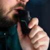 User inhaling from the Dr. Dabber Ghost 2 during a concentrate session