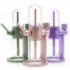 Stündenglass Gravity Infusers displayed in green, Desert Rose and purple