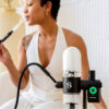 Black Stündenglass Gravity Infuser being used indoors with its hose
