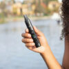 XMax V4 Pro held outdoors in one hand to show the compact portable design