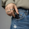 Compact G Pen 510 OG battery being placed into a front jeans pocket