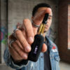 Man holding a G Pen 510 OG battery and cartridge close to the camera