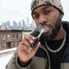 Man using a G Pen 510 OG battery outdoors in winter weather