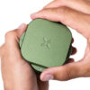 Greenstone PAX Grinder held in both hands with the magnetic top section being rotated