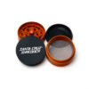 Orange Split Series grinder taken apart to show the grinding chamber, screen and collector